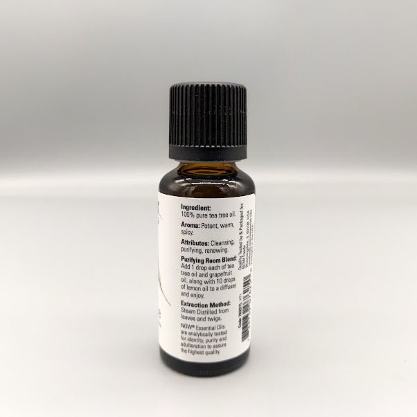 Aceite de árbol de té NOW 1 oz Melaleuca alternifolia 100% puro — etiqueta con los ingredientes